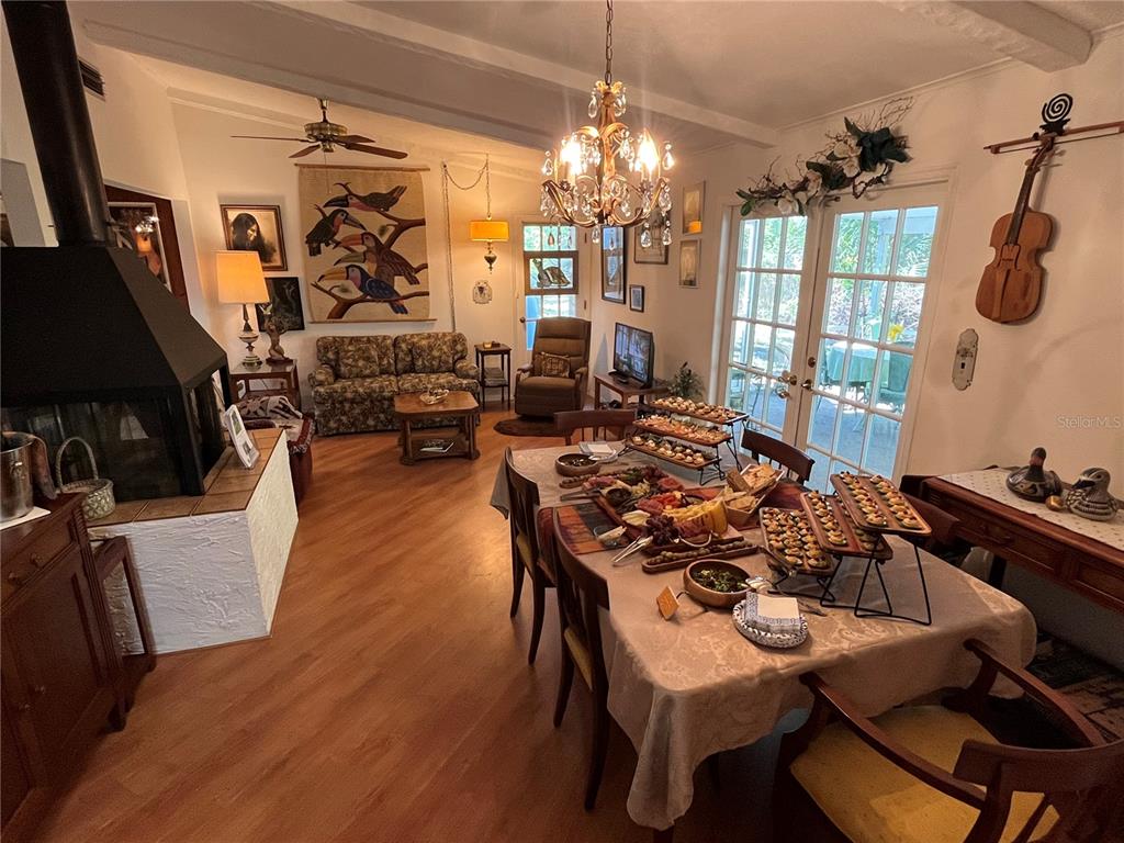 550 46th Street Sarasota, FL 34234 - Photo 21 of 48 a living room with furniture a chandelier and a dining table