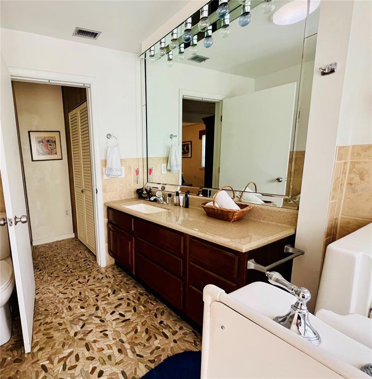 550 46th Street Sarasota, FL 34234 - Photo 25 of 48 a bathroom with a sink double vanity and a mirror
