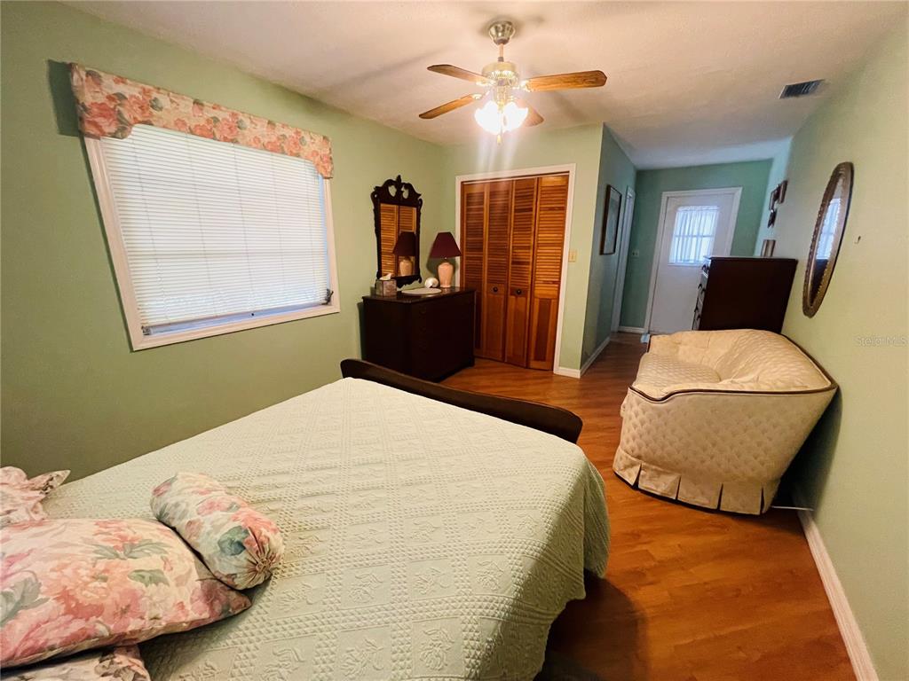 550 46th Street Sarasota, FL 34234 - Photo 28 of 48 a bedroom with a bed and wooden floor