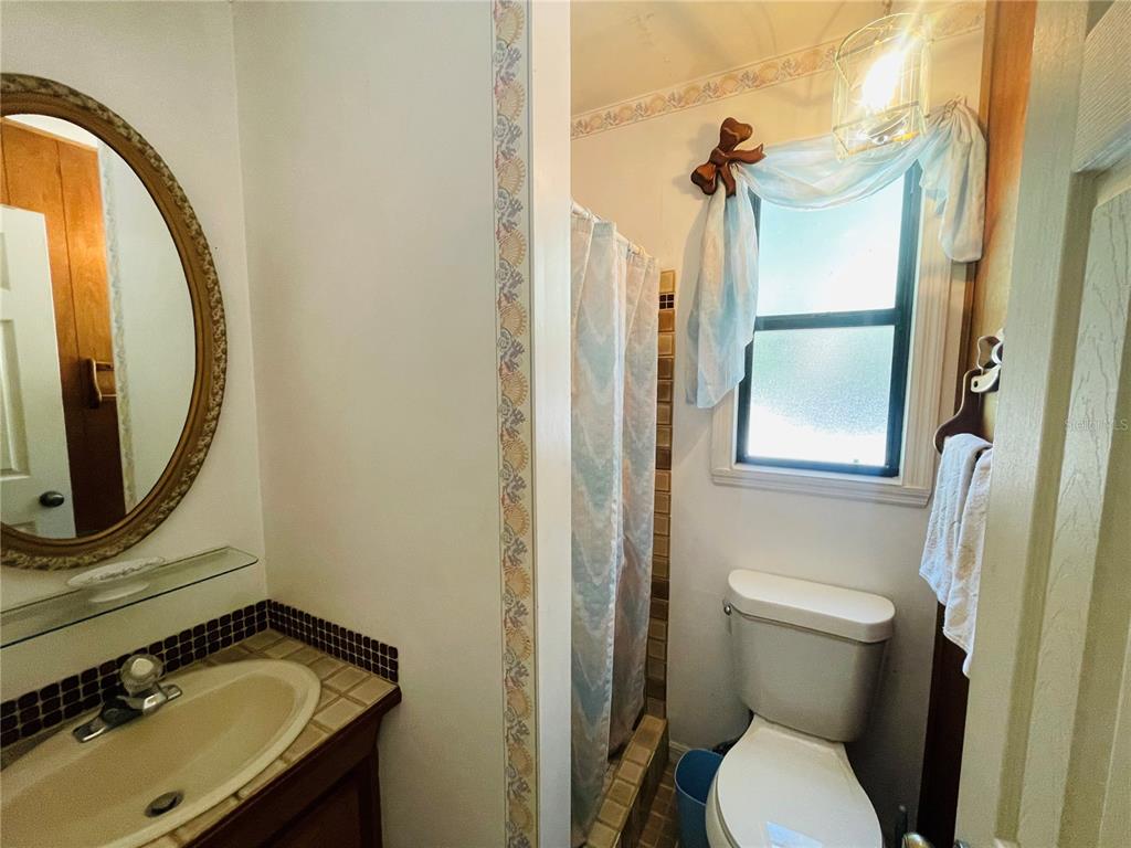 550 46th Street Sarasota, FL 34234 - Photo 29 of 48 a bathroom with a sink and a mirror