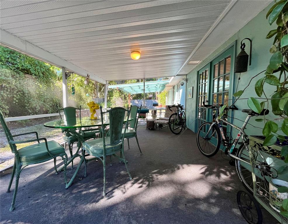 550 46th Street Sarasota, FL 34234 - Photo 33 of 48 a dining room with furniture and a garden