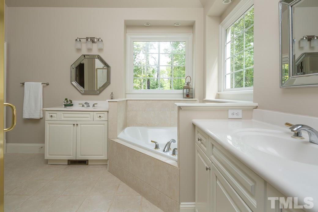 4901 Grilse Way Raleigh, NC 27613 - Photo 11 of 19 Gorgeous master bath with NEW PAINT, HIS & HERS vanities, NEW mirrors and NEW light fixtures.