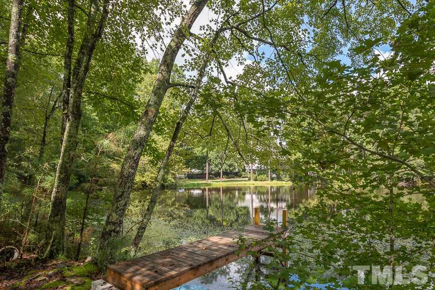 4901 Grilse Way Raleigh, NC 27613 - Photo 18 of 19 Featuring a pond, this home is an oasis in the middle of a bustling city.