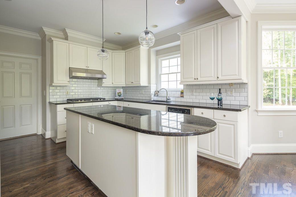 4901 Grilse Way Raleigh, NC 27613 - Photo 6 of 19 The open kitchen offers GRANITE counters, work island and NEW TILE backsplash.