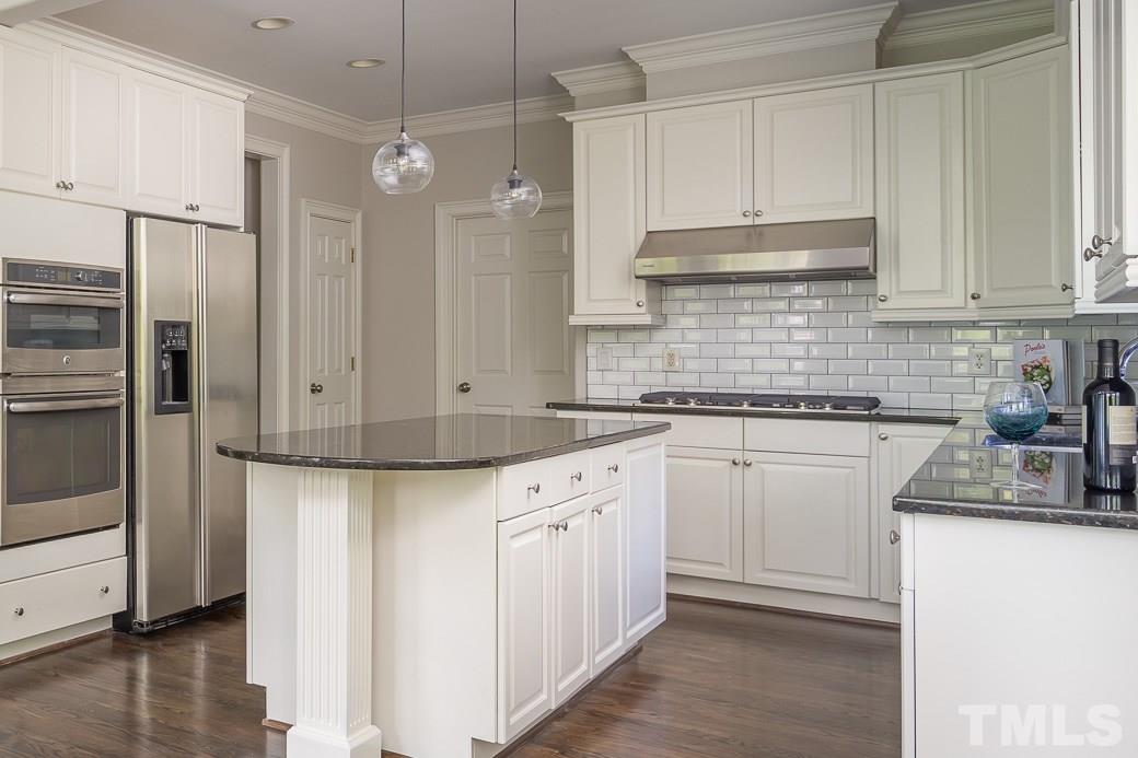 4901 Grilse Way Raleigh, NC 27613 - Photo 7 of 19 This Kitchen has it all! WALL OVENS, GRANITE counters, TILE backsplash, quality STAINLESS STEEL appliances, large island and plenty of storage.