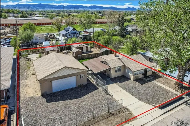 an aerial view of a house with a yard swimming pool and mountain view