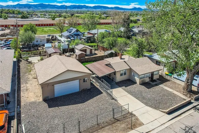 an aerial view of a house with a yard swimming pool and mountain view