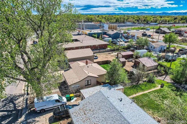 an aerial view of a house with a yard