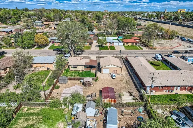 an aerial view of residential houses with outdoor space and river