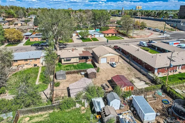an aerial view of a swimming pool with outdoor seating and yard