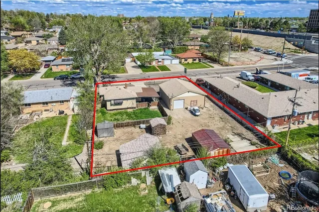 an aerial view of residential houses with outdoor space and lake view