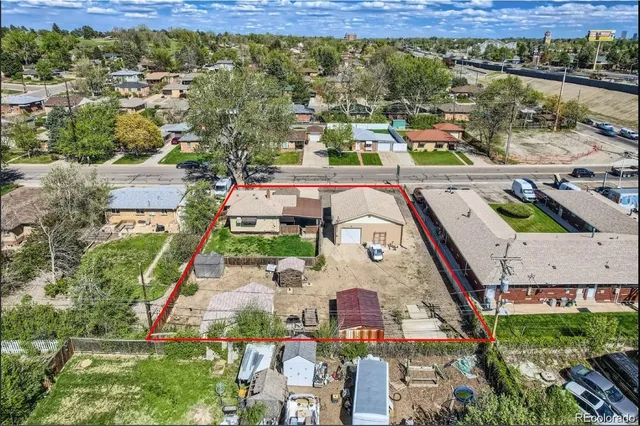 an aerial view of residential houses with outdoor space and ocean view