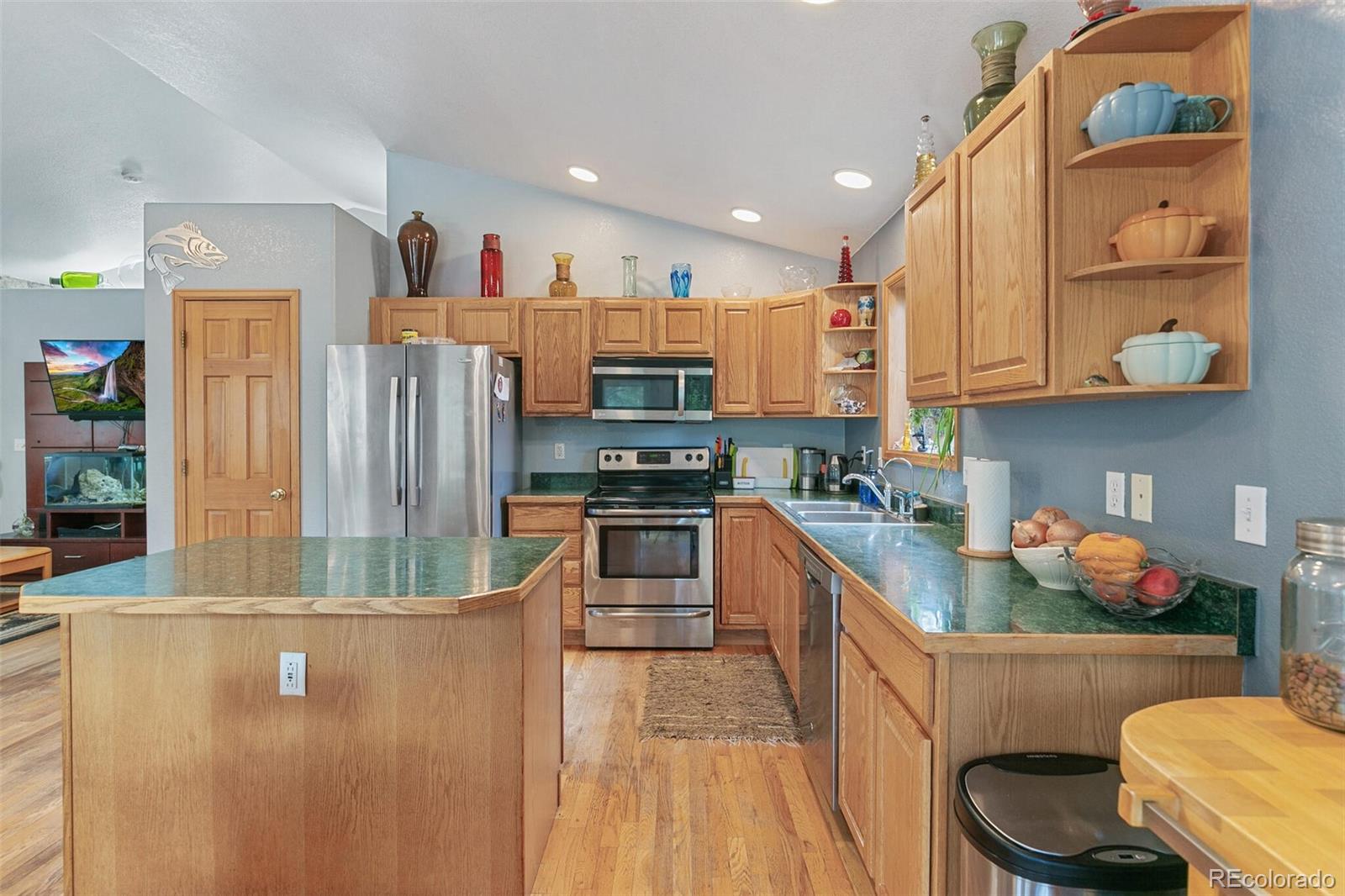 30 Bristlecone Circle Bailey, CO 80421 - Photo 11 of 35 a kitchen with stainless steel appliances granite countertop a refrigerator a stove and a sink with wooden cabinets