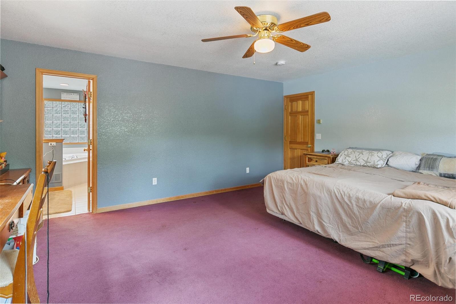 30 Bristlecone Circle Bailey, CO 80421 - Photo 18 of 35 a bedroom with a bed and a chandelier