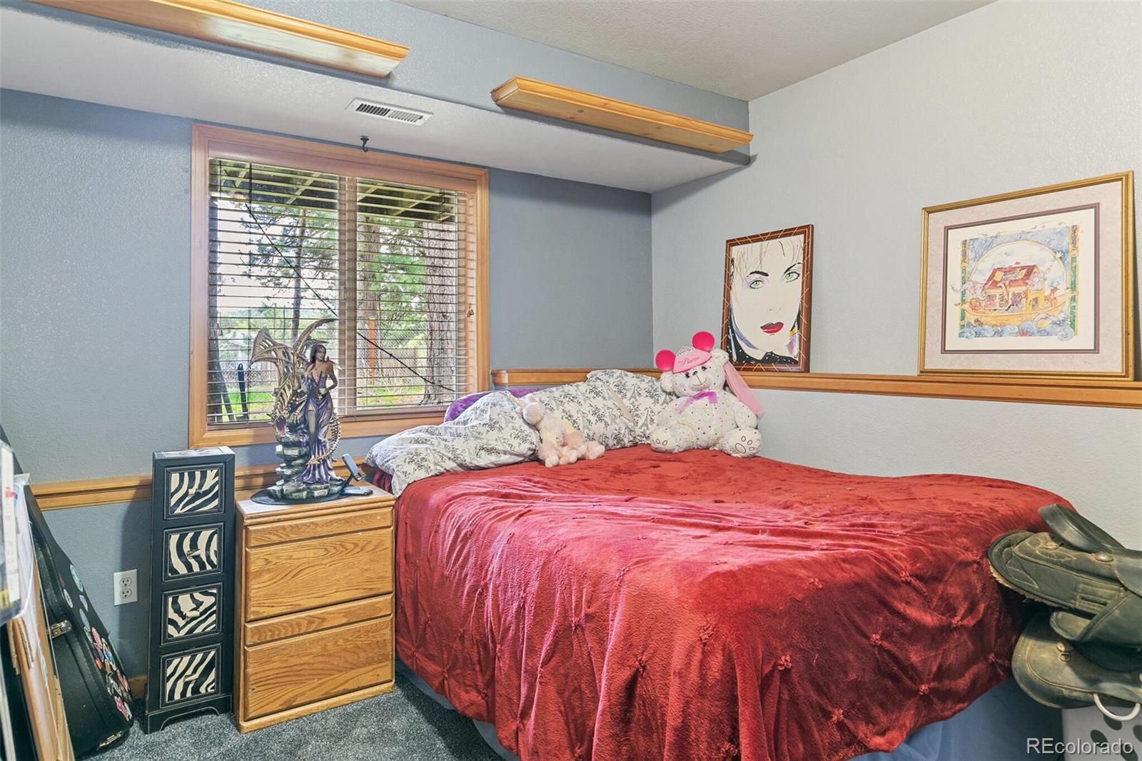 30 Bristlecone Circle Bailey, CO 80421 - Photo 24 of 35 a bedroom with a bed and wooden floor