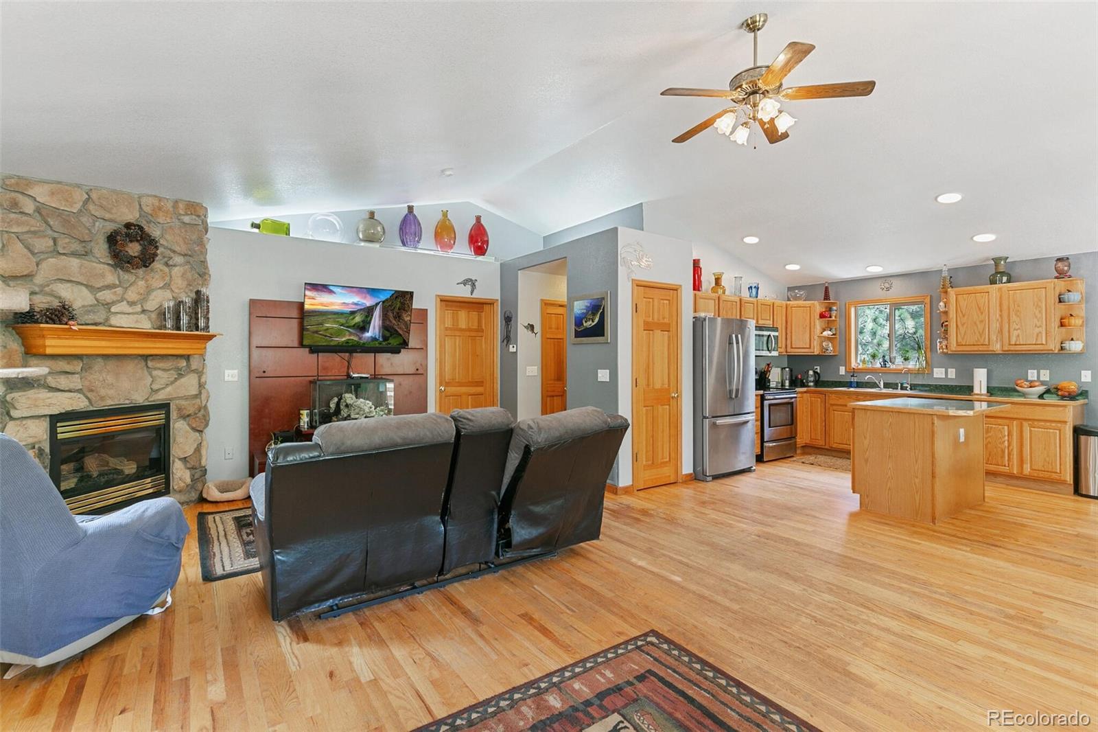 30 Bristlecone Circle Bailey, CO 80421 - Photo 3 of 35 a living room with furniture and a fireplace