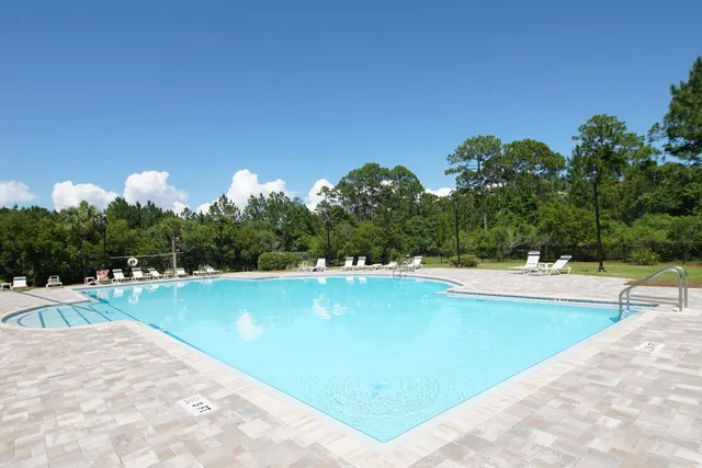 a view of a swimming pool and lounge chairs
