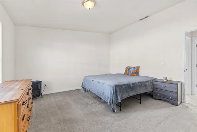 a bedroom with a bed and a cabinets