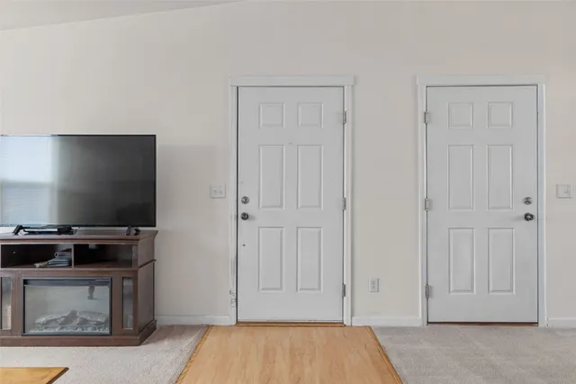 a view of room with flat screen tv and washer & dryer