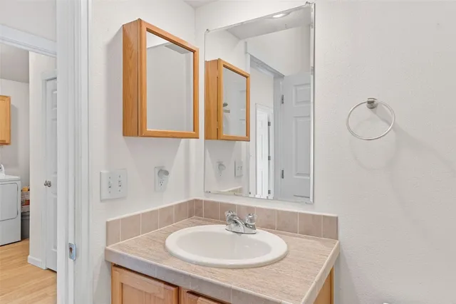 a bathroom with a sink and a mirror