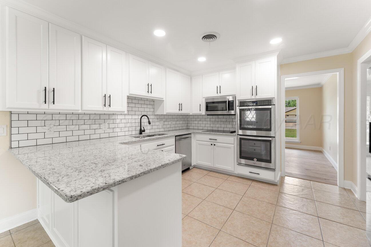 7204 Southwest 39th Avenue Amarillo, TX 79109 - Photo 10 of 51 a kitchen with appliances cabinets and a sink