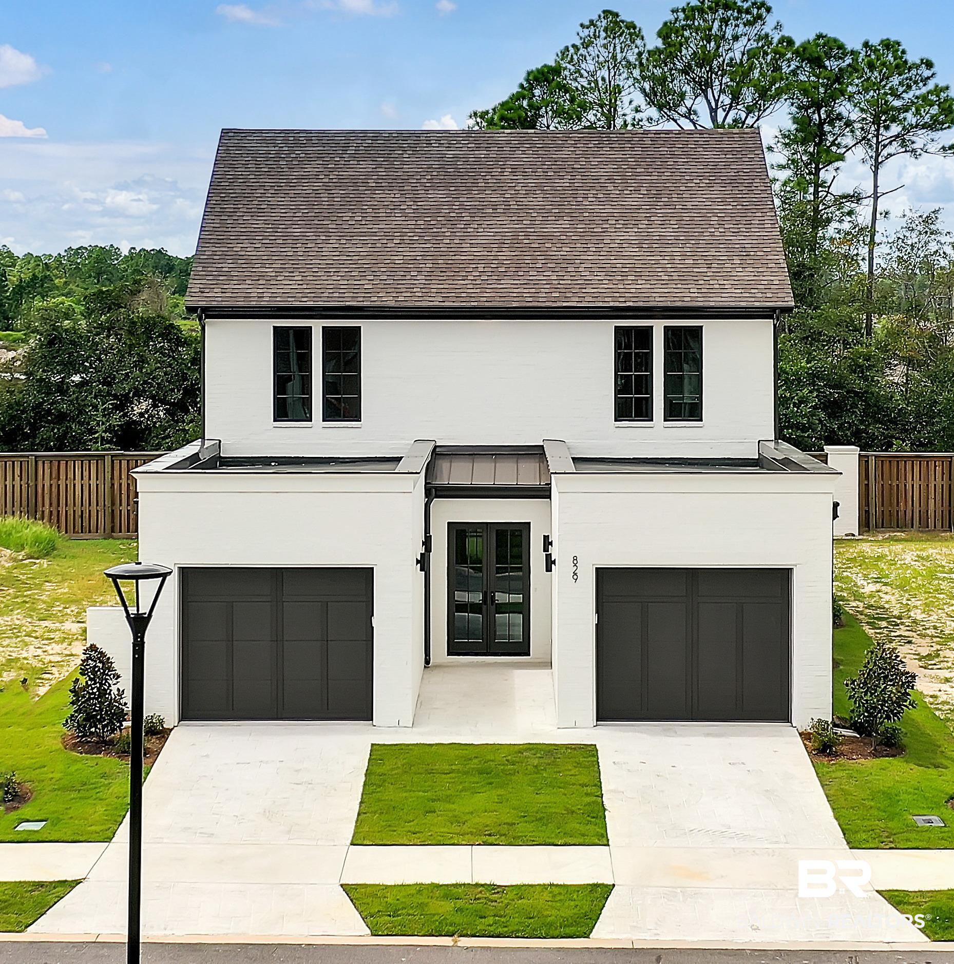 829 Inlet Circle Gulf Shores, AL 36542 - Photo 1 of 31 View of front facade featuring a garage and a front lawn