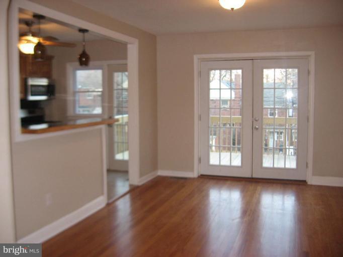 916 Andover Road Baltimore, MD 21218 - Photo 2 of 30 wooden floor in an empty room with a window