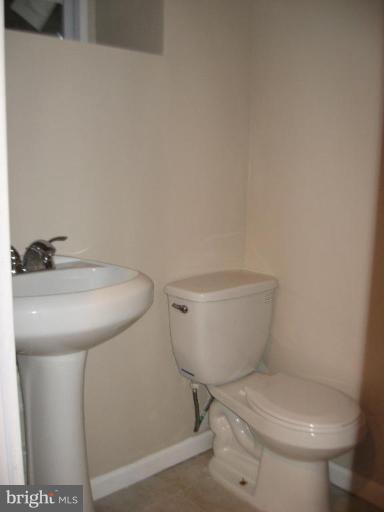 916 Andover Road Baltimore, MD 21218 - Photo 11 of 30 a white toilet sitting next to a sink