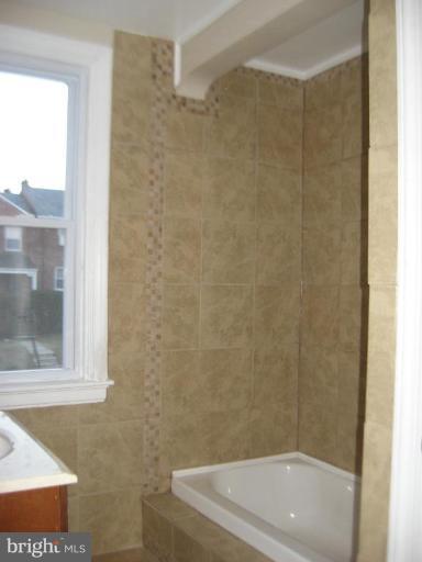 916 Andover Road Baltimore, MD 21218 - Photo 12 of 30 a bath tub sitting next to a shower
