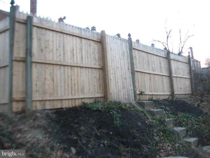 916 Andover Road Baltimore, MD 21218 - Photo 13 of 30 a view of a small yard with wooden fence