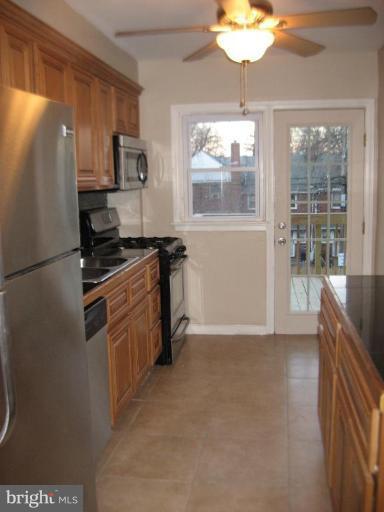 916 Andover Road Baltimore, MD 21218 - Photo 18 of 30 a kitchen with stainless steel appliances granite countertop a stove a sink and a refrigerator