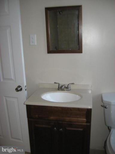 916 Andover Road Baltimore, MD 21218 - Photo 23 of 30 a bathroom with a sink vanity and a toilet