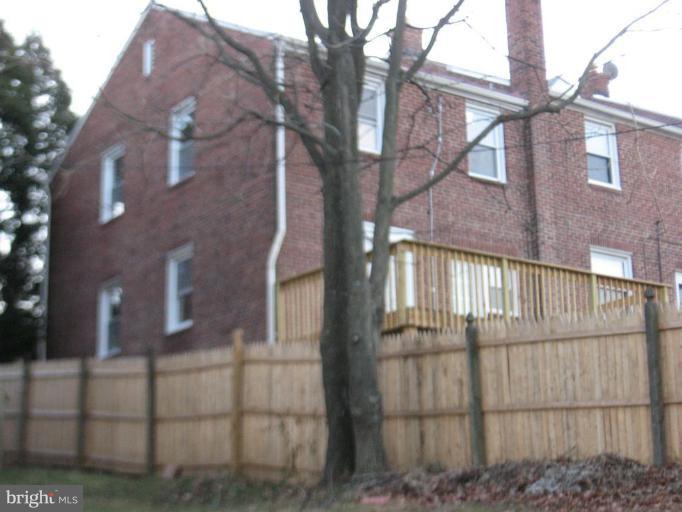 916 Andover Road Baltimore, MD 21218 - Photo 24 of 30 a view of a brick house next to a yard