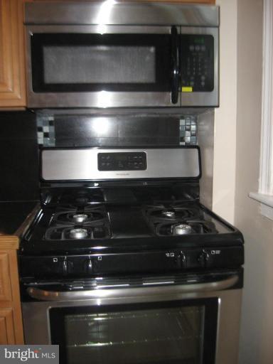 916 Andover Road Baltimore, MD 21218 - Photo 27 of 30 a stove top oven sitting inside of a kitchen