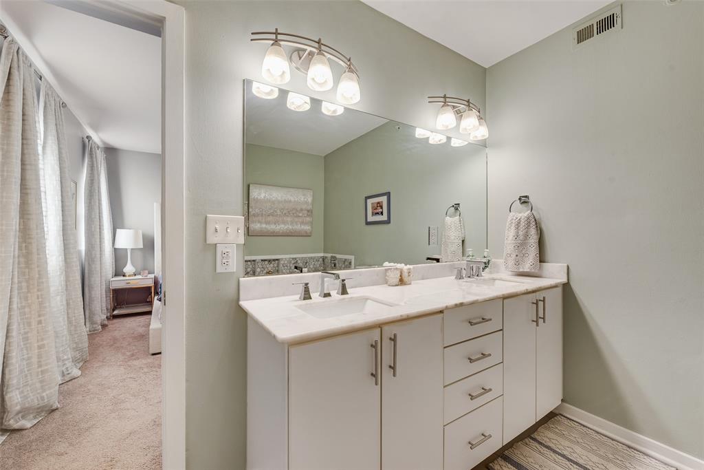 3922 Gilbert Avenue, Unit 220 Dallas, TX 75219 - Photo 11 of 19 a bathroom with a double vanity sink and a mirror