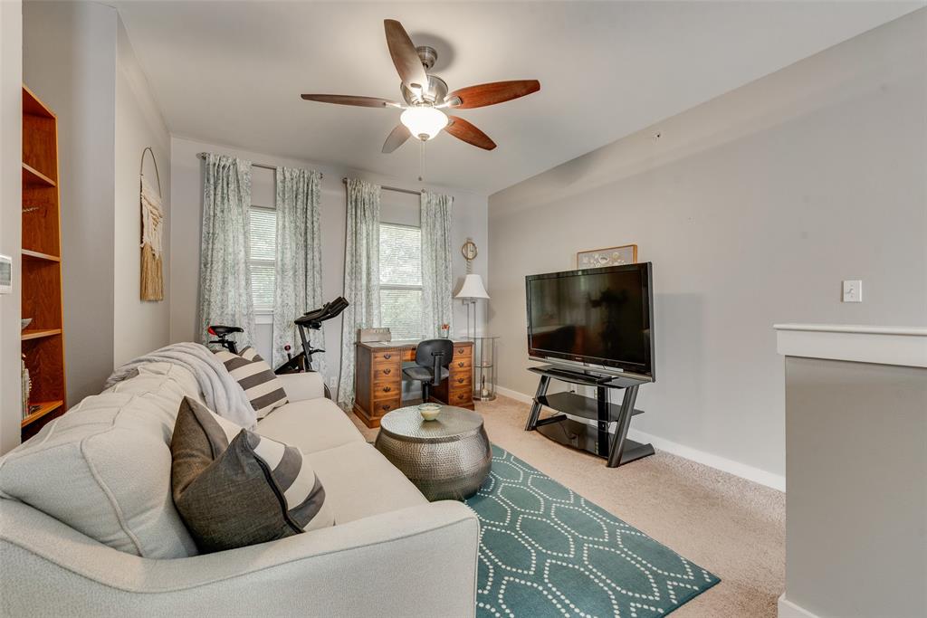 3922 Gilbert Avenue, Unit 220 Dallas, TX 75219 - Photo 12 of 19 a living room with furniture and a flat screen tv