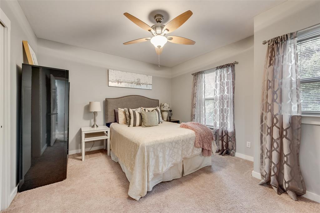 3922 Gilbert Avenue, Unit 220 Dallas, TX 75219 - Photo 13 of 19 a bedroom with a bed and a chandelier