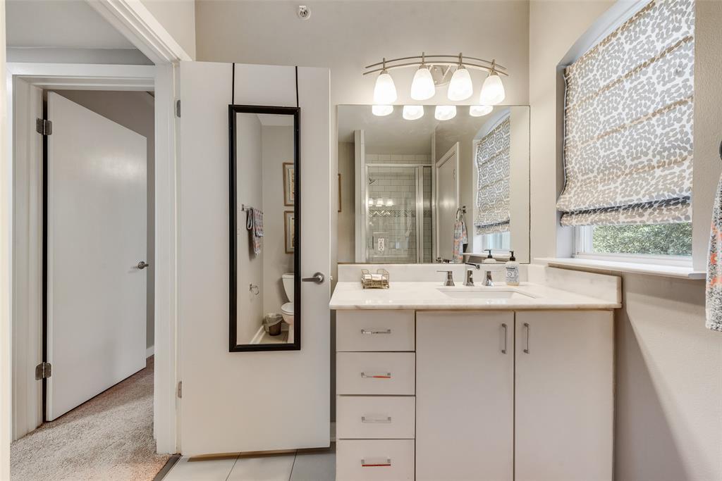3922 Gilbert Avenue, Unit 220 Dallas, TX 75219 - Photo 16 of 19 a bathroom with a double vanity sink and a mirror
