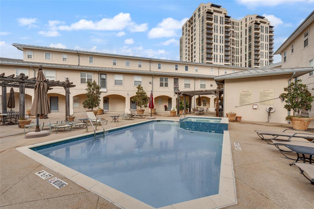 3922 Gilbert Avenue, Unit 220 Dallas, TX 75219 - Photo 18 of 19 a view of a swimming pool with outdoor seating