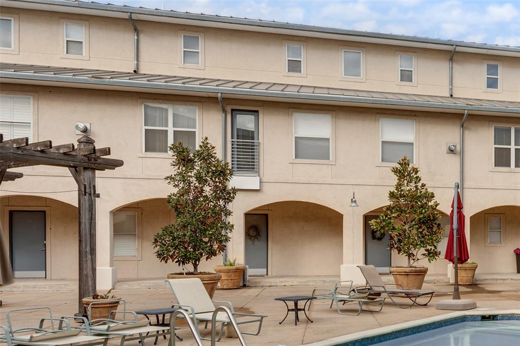 3922 Gilbert Avenue, Unit 220 Dallas, TX 75219 - Photo 19 of 19 a view of a white house with large windows
