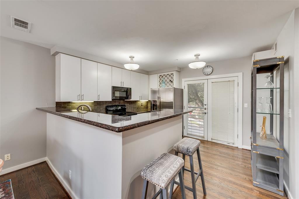 3922 Gilbert Avenue, Unit 220 Dallas, TX 75219 - Photo 5 of 19 a kitchen with stainless steel appliances granite countertop a refrigerator and a stove top oven