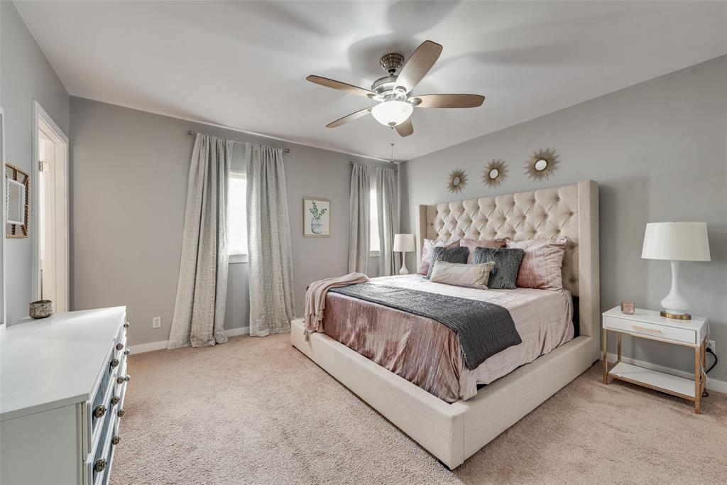 3922 Gilbert Avenue, Unit 220 Dallas, TX 75219 - Photo 8 of 19 a spacious bedroom with a bed and a chandelier