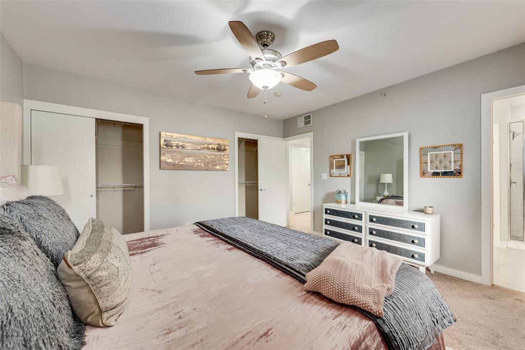 3922 Gilbert Avenue, Unit 220 Dallas, TX 75219 - Photo 9 of 19 a bedroom with a large bed and a chandelier
