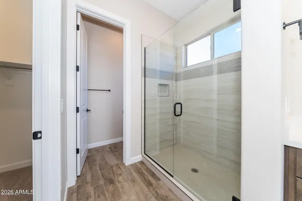 a bathroom with a shower and a sink