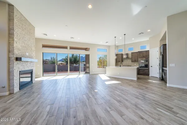 a view of a kitchen with wooden floor and a window