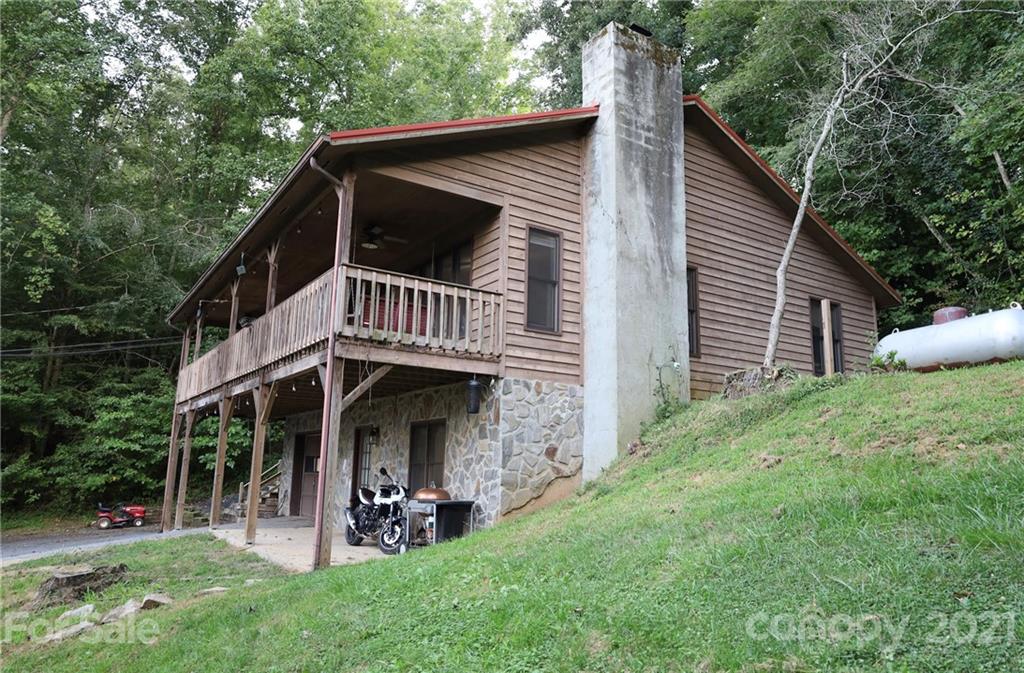 263 Cedar Rock Road Waynesville, NC 28786 - Photo 1 of 20 a front view of a house with a yard