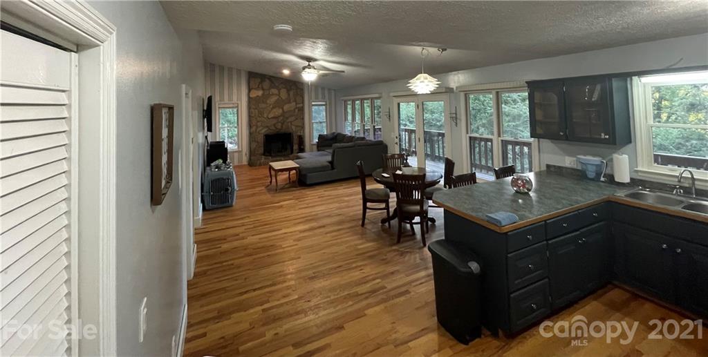 263 Cedar Rock Road Waynesville, NC 28786 - Photo 12 of 20 a living room with furniture a large window and wooden floor