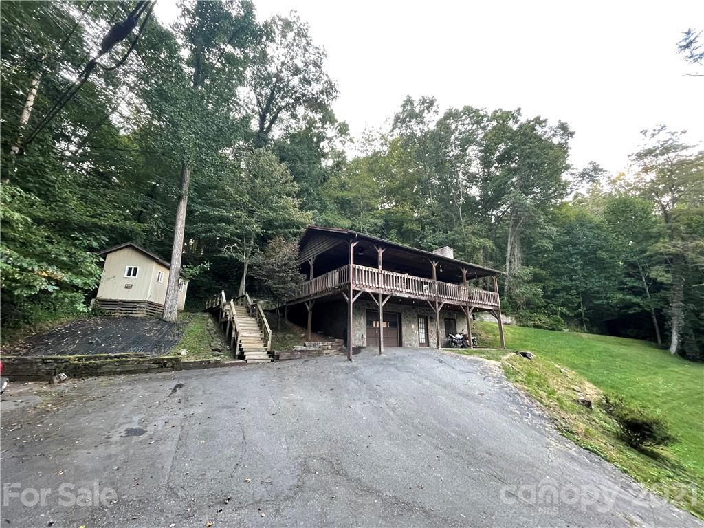 263 Cedar Rock Road Waynesville, NC 28786 - Photo 20 of 20 a view of house with backyard and trees