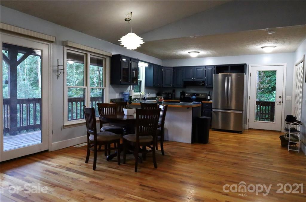 263 Cedar Rock Road Waynesville, NC 28786 - Photo 4 of 20 a view of a dining room with furniture window and wooden floor