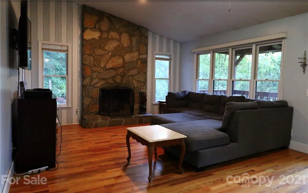 263 Cedar Rock Road Waynesville, NC 28786 - Photo 5 of 20 a living room with furniture and a fireplace